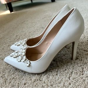 White pointed-toe pumps
